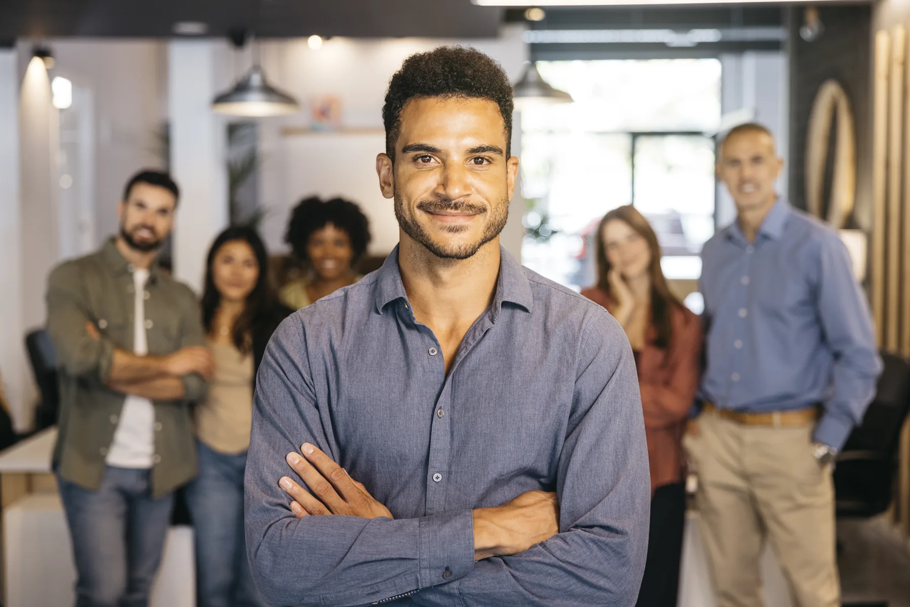 Man standing in front of his team in a workplace