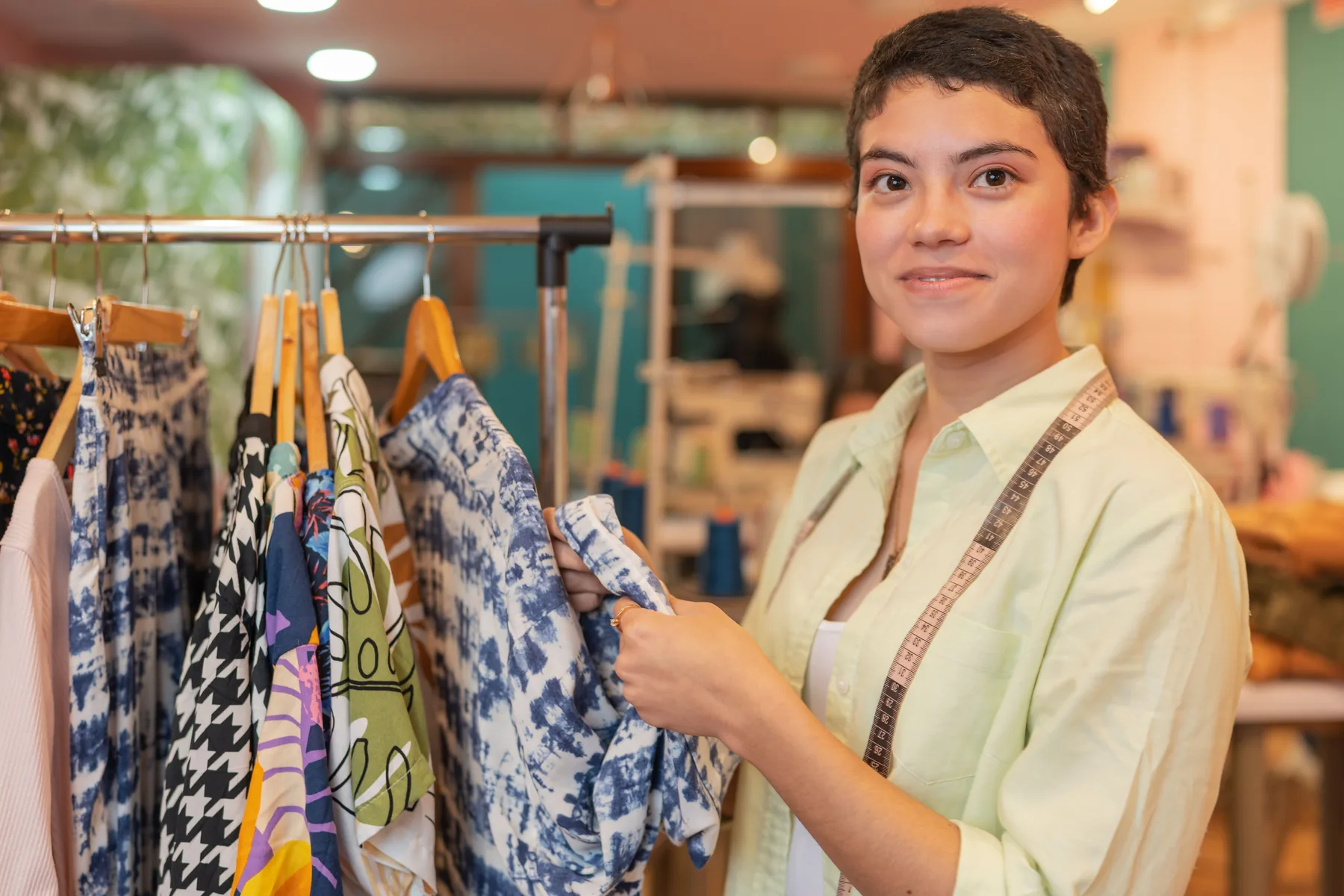 Woman arranging clothes on a shop rack