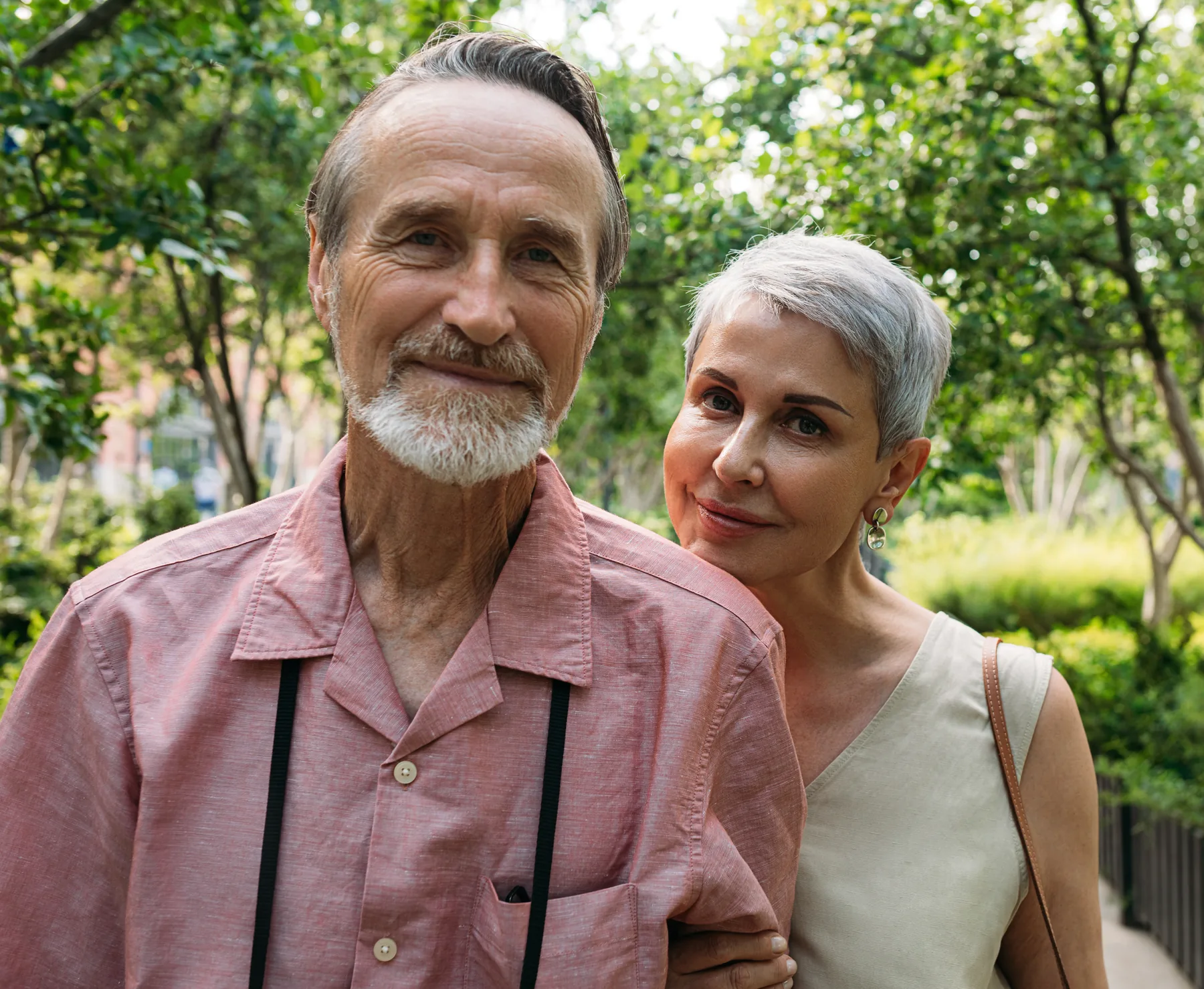 Older couple posing together in a garden