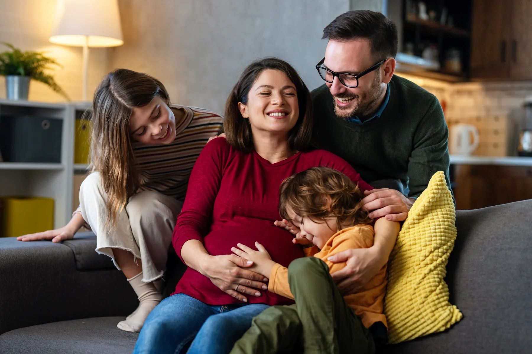 Growing family spending time together at home